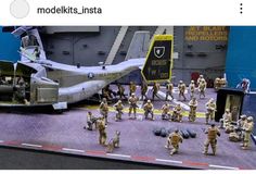 a group of toy soldiers standing next to an airplane