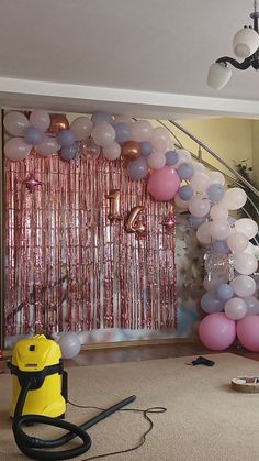 a room filled with balloons and a blow dryer