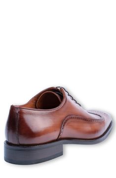 Elevate your wardrobe with a medallion wingtip oxford constructed from hand-painted leather with elegant broguing. Lace-up style Leather upper and lining/synthetic sole Made in Turkey Cognac Wingtip Oxfords For Semi-formal Occasions, Classic Brown Wingtip Derby Shoes, Cognac Wingtip Oxfords With Leather Lining, Cognac Wingtip Oxfords For Business Casual, Semi-formal Cognac Oxfords With Brogue Detailing, Classic Wingtip Oxfords In Cognac, Formal Cognac Oxfords With Goodyear Welt, Classic Cognac Wingtip Oxfords, Timeless Cognac Dress Shoes With Brogue Detailing