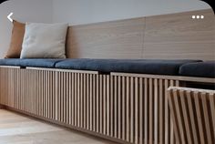 a wooden bench sitting next to a window in a room