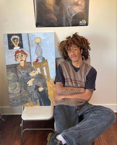 a man sitting in front of two paintings