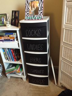 there is a book shelf with chalk writing on it