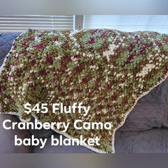 a crocheted baby blanket with the words $ 45 fluffy cranberry camo baby blanket