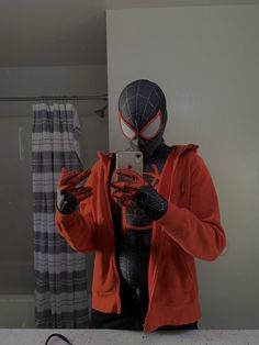 a spider man taking a selfie in the bathroom