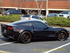 a black sports car parked in a parking lot