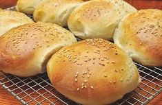 bread rolls with sesame seeds on a cooling rack