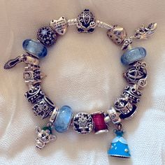 Authentic Pandora Disney Cinderella Bracelet With 16 Charms And 2 Clips. Includes Cinderella’s Dress, Sparkling Slipper, Pumpkin Coach, Crown, 3 Signature Color Muranos, Castle, Gus Gus, Suzy And A Dream Is A Wish Your Heart Makes. 3 Of The Charms Have Been Worn A Few Times. The Rest Have Been Sitting On The Bracelet In My Jewelry Box. Selling This As A Set Right Now. Themed Jewelry For Disney Fan Events, Disney Pandora Bracelet Ideas, Cinderella Pandora Bracelet, Pandora Jewelry Charms Disney, Pandora Disney Collection, Disney Pandora Bracelet, Pumpkin Coach, Disney Charm Bracelet, Pandora Disney