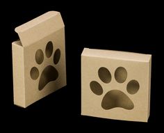 two cardboard boxes with paw prints on the front and one has a small box in the middle