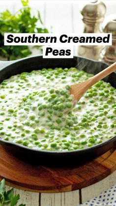 peas being cooked in a skillet with a wooden spoon