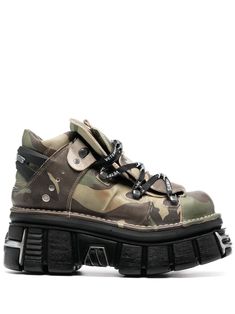 x New Rock leather platform sneakers from VETEMENTS featuring khaki, calf leather, smooth grain, camouflage print, silver-tone logo plaque, logo-engraved silver-tone hardware, round toe, front lace-up fastening, platform sole and chunky rubber lug sole. Size Info IT Color Detail Green Made In Spain Material 100% CALFSKIN Season One Fall-Winter Season Two Fall-Winter Product sneakers Brand Vetements X New Rock Size And Fit Heel 3,3 in / 8,5 cm; Platform 2,2 in / 5,5 cm Vetements Shoes, Sneakers Green, New Rock, Dream Style, Crossbody Tote Bag, Camouflage Print, Moon Boots, Silver Engraving, Platform Sneaker