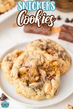 two chocolate chip cookies on a white plate with the title text overlay reads best ever snickkers cookies