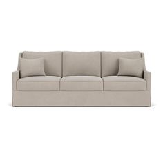 an image of a couch with pillows on the top and bottom, in light grey linen