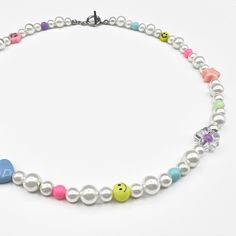 Define your style with the bright design of our premium pearl and bead necklace: Offers a clean, stand out design, versatile and durable, stands up to water, sweat, and more. Premium materials: Built to last — Our Premium Pearl & Bead Necklace has been crafted using different sized white pearls, colored beads and the finest silver hardware to hold it all together. This piece is the perfect piece when worn on it's own or when stacked with other white or silver jewelry. Custom fit: Our jewelry is White Pearl Choker Necklace With Colorful Beads, Multicolor Pearl Necklace With Colorful Beads, Rainbow Round Beads Pearl Necklace, Colorful Multi-strand Pearl Beaded Necklaces, Rainbow Pearl Necklace With Colorful Round Beads, Pearl And Bead Necklace, Pearl Bead Necklace, Define Your Style, Pearl Beaded Necklace