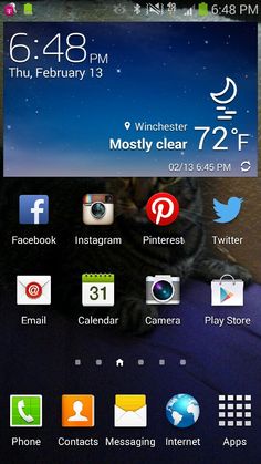 a close up of a cell phone with icons on the screen and an image of a cat