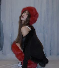 a woman with long hair wearing a fur hat