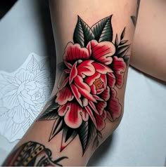 a woman's leg with a flower tattoo on it