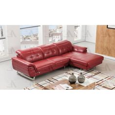 a red leather sectional sofa sitting on top of a rug