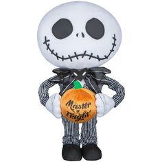 the plush toy is wearing a striped suit and holding an orange pumpkin in his hand