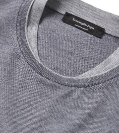 a grey t - shirt with a black label on it