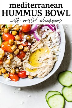 a white bowl filled with rice and vegetables next to cucumbers on the side