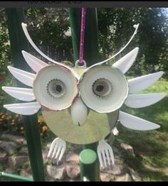 an owl made out of toilet paper on top of a green pole