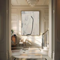 an elegant hallway with white walls and flooring, chandelier and painting on the wall