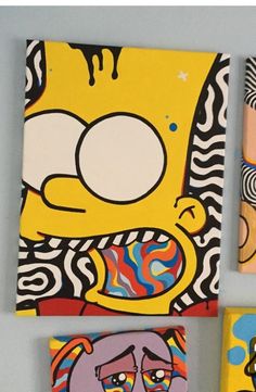 three square paintings with cartoon characters painted on them, one in yellow and the other in blue