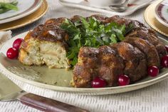 there is a cake on the plate with cranberries around it and garnished with parsley