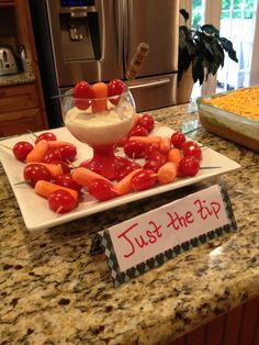 a plate with some food on it and a sign that says just the dip next to it