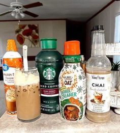 there are many different drinks on the counter together, including iced coffee and hot chocolate