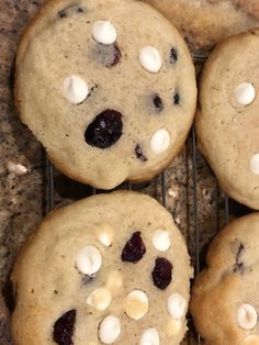 four cookies with marshmallows and cranberries on a cooling wire rack