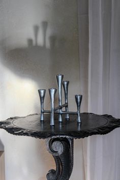 a table that has some silver cups on it