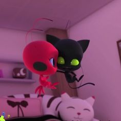 two black and white cats sitting next to each other in a room with pink walls