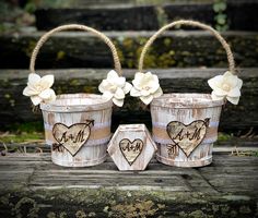 two wooden buckets with hearts and flowers on them