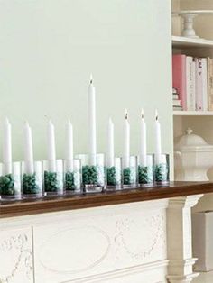 there are many candles on the mantle in this room