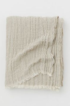 a white blanket with fringes on it