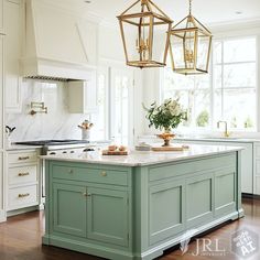 a kitchen island with two hanging lights above it