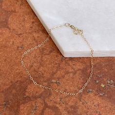 14KT yellow gold flat cable link chain bracelet. A delicate and minimal chain bracelet to wear sold or layering with more bracelet. 7" in Length 1.30mm in width 14KT Gold Spring Lock Clasp Weight: .34 gram Stamped 14K Saint Jewelry, Link Chain Bracelet, Gold Flats, 14kt Gold, Link Chain, Chain Bracelet, Layering, Cable, Yellow Gold