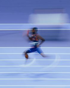 a blurry photo of a man running on a track