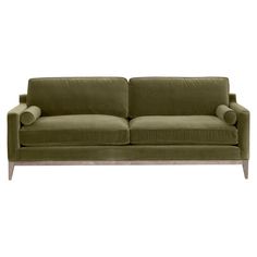 a green couch sitting on top of a white floor