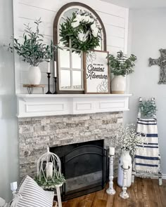 a fireplace decorated with greenery and white flowers