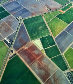 an aerial view of farmlands and fields in the country