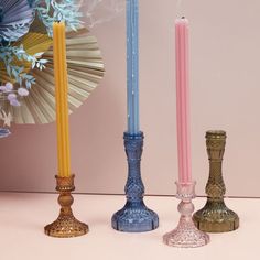 three different colored candles sitting next to each other