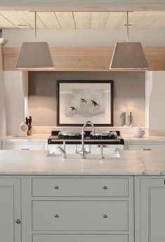 a kitchen with an island, stove and sink in the middle of it's counter space