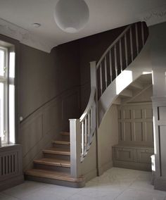 an empty room with stairs and windows