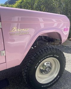 a pink truck is parked on the street