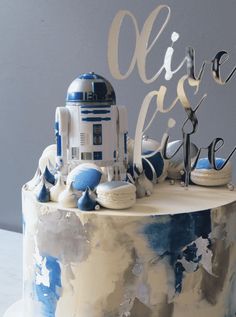 a star wars themed birthday cake with a droid on top