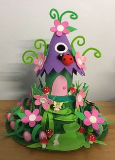 this is a cake made to look like a house with flowers and ladybugs on it