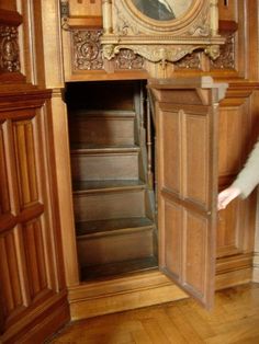 an open wooden door with a clock on the wall