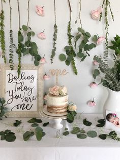 a table topped with a cake and flowers